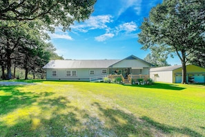 A single-story house with a sloped roof, a front porch, and a garage. - Pool, Large Porch! Country Home Near Roaring River (Seligman)