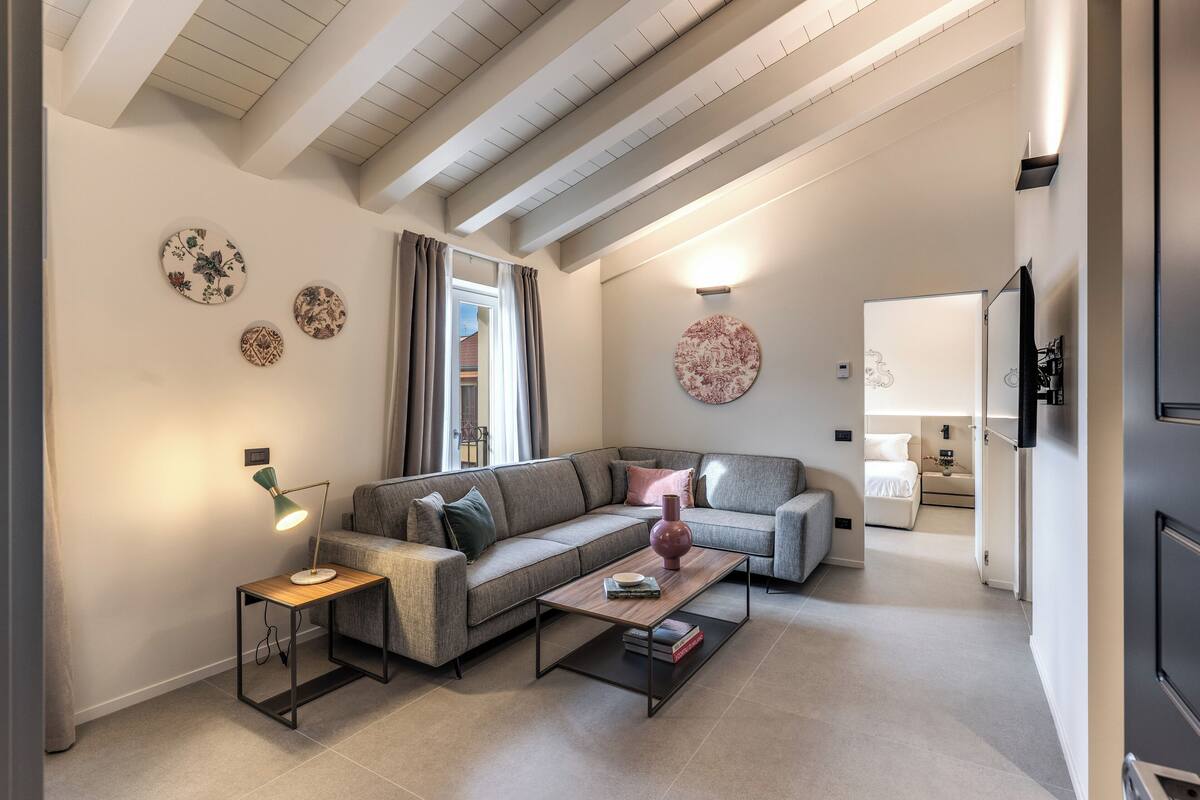 A modern living room with a sofa, coffee table, and decorative plates on the wall.