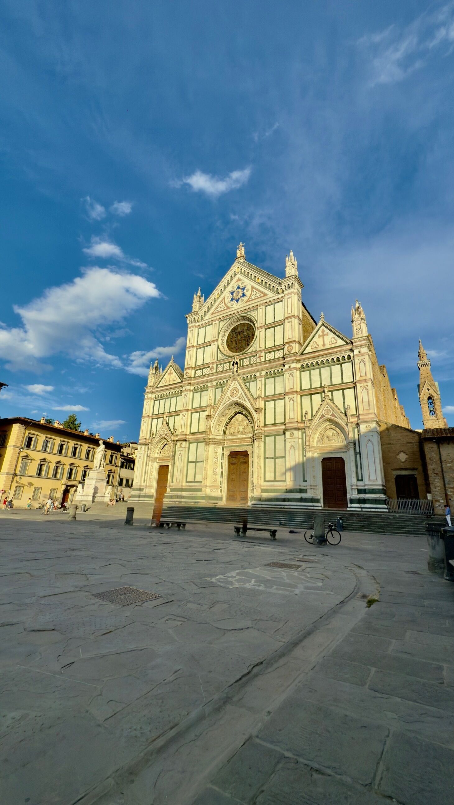 A large, historic building with a prominent central dome and multiple spires.
