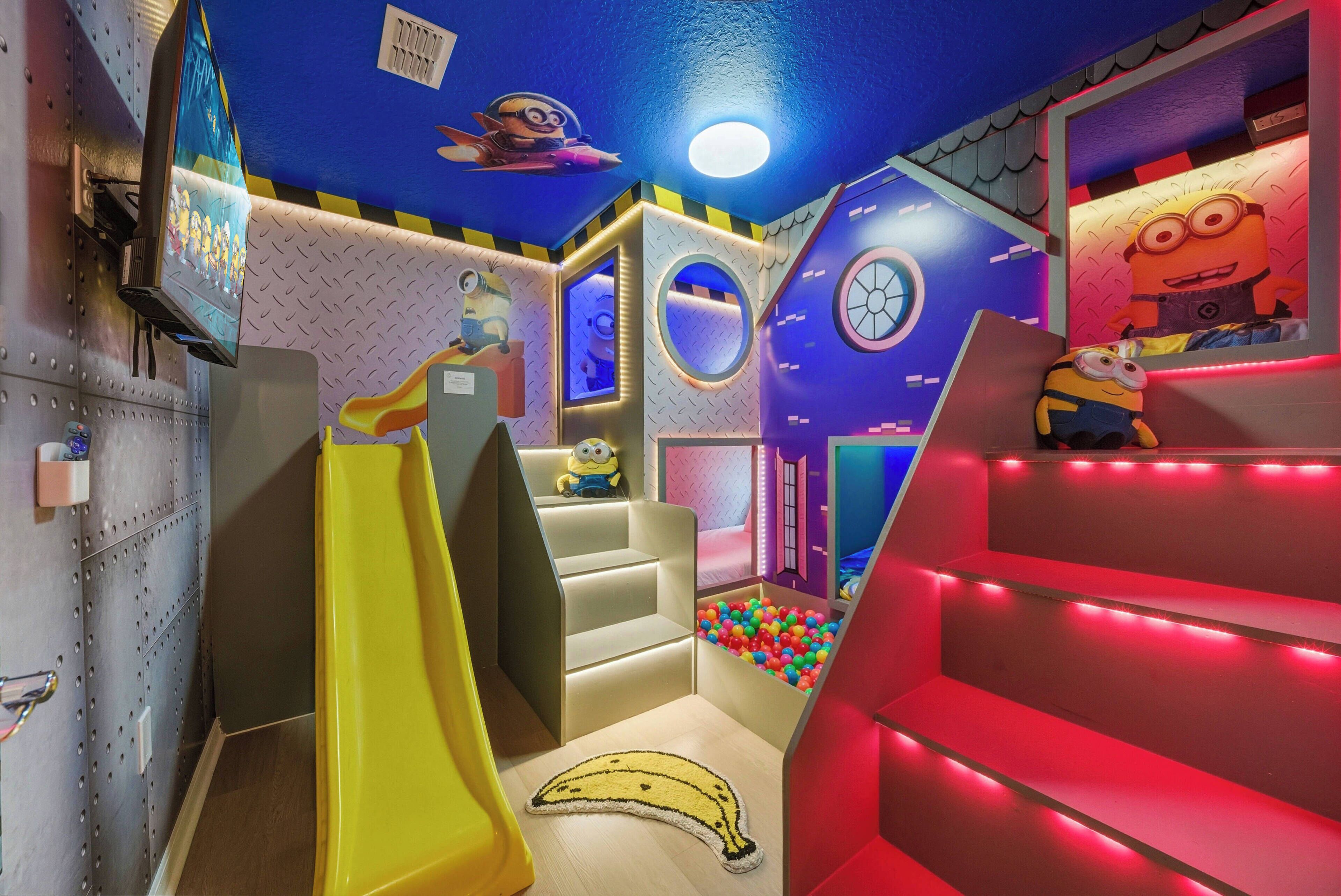A children's play area with slides, a ball pit, and Minion-themed decorations.