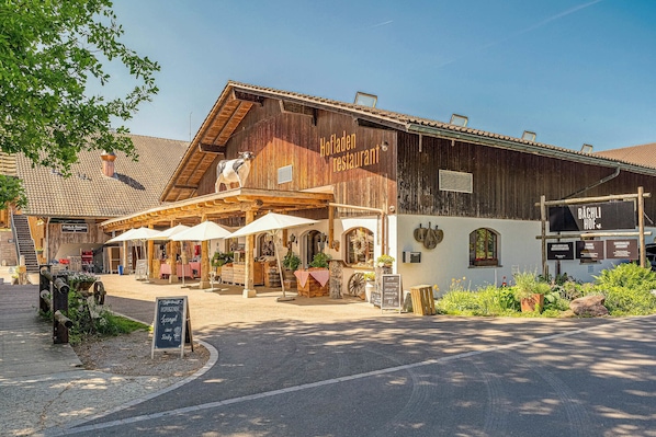 A rustic wooden building with a sign for a restaurant.