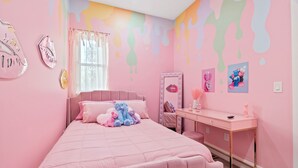 A pink-themed bedroom with a bed, a desk, and a vanity. - Pink Mini Unit With Pool in Philly (Philadelphia)