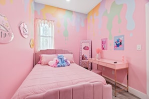 A pink-themed bedroom with a bed, bedside table, and a desk. - FIFA World Cup Philly Stay - Pink Mini Unit With Pool (Philadelphia)