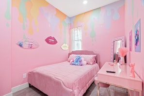 A pink-themed bedroom with a bed, dresser, and wall art including lips and a heart. - FIFA World Cup Philly Stay - Pink Mini Unit With Pool (Philadelphia)
