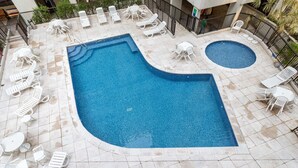 A pool area with two pools, surrounded by white lounge chairs and tables. - Near Rodrigo de Freitas Lagoon Pc308 (Rio de Janeiro)