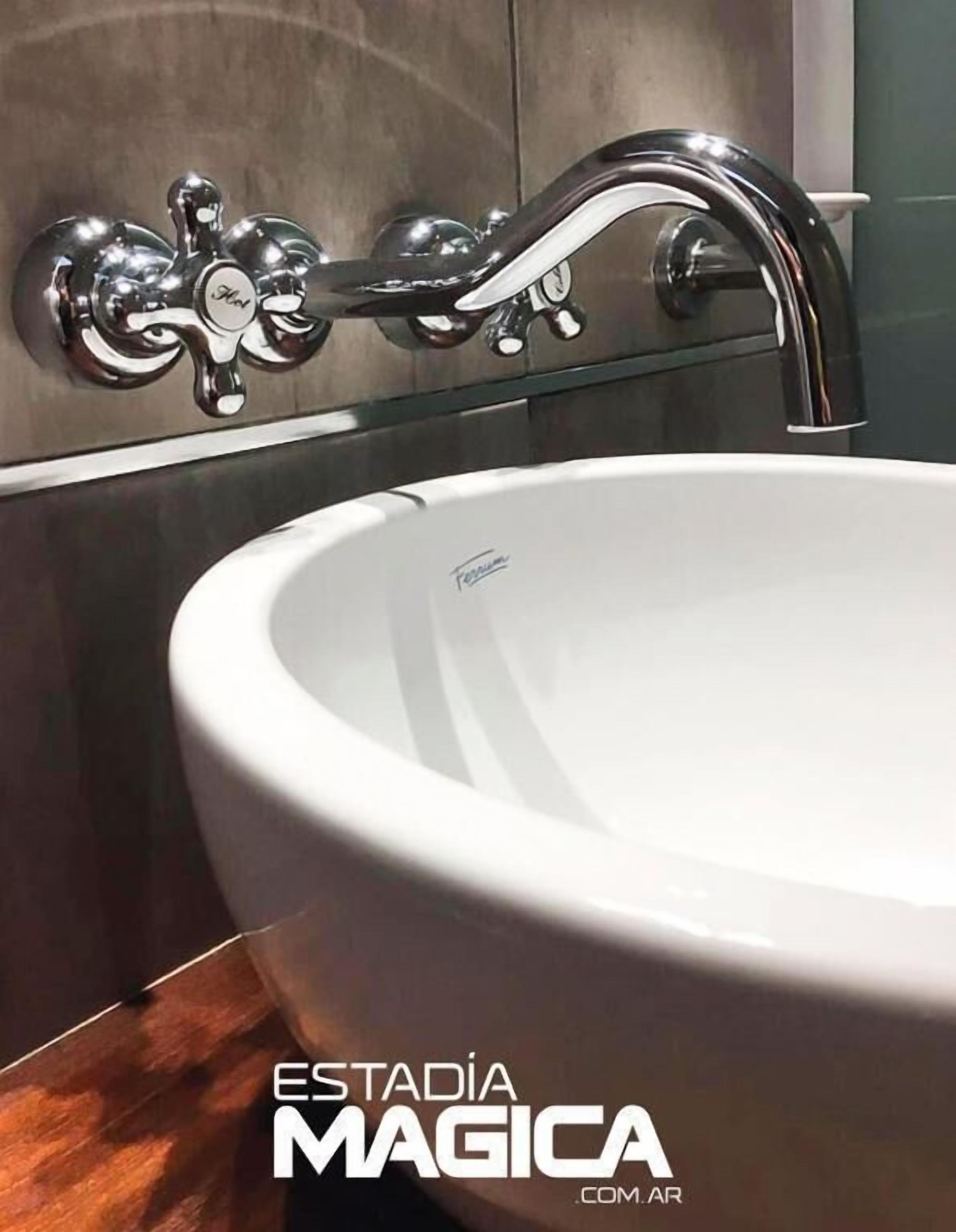 Un baño moderno con un lavabo de cerámica blanca y un grifo cromado.