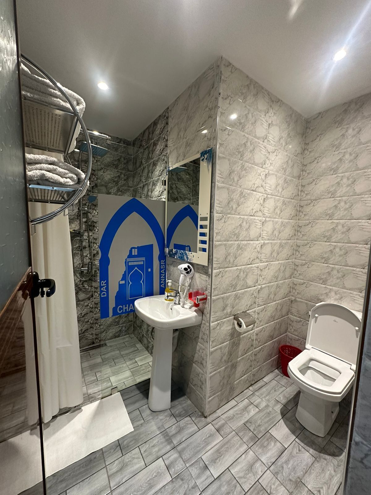 Separate tub and shower, hair dryer, towels, shampoo