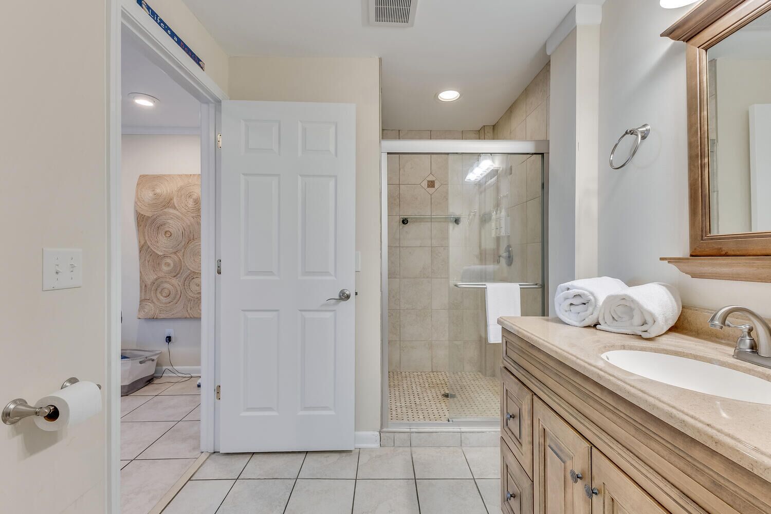 A modern bathroom with a shower, a sink, and a vanity.