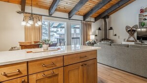 A modern kitchen with wooden cabinets, a marble countertop, and a large island. - Bright & Modern 3BR/2BA Retreat 644 (Mammoth lakes)