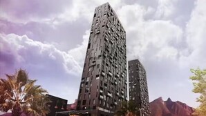 Un moderno grattacielo alto, caratterizzato da un design unico e dalle linee geometriche.