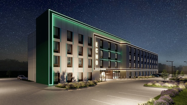 A modern hotel with a prominent "ECHO" sign, featuring a clean, rectangular design with multiple windows and a well-lit entrance. - Echo Suites Extended Stay By Wyndham Bozeman (Bozeman)