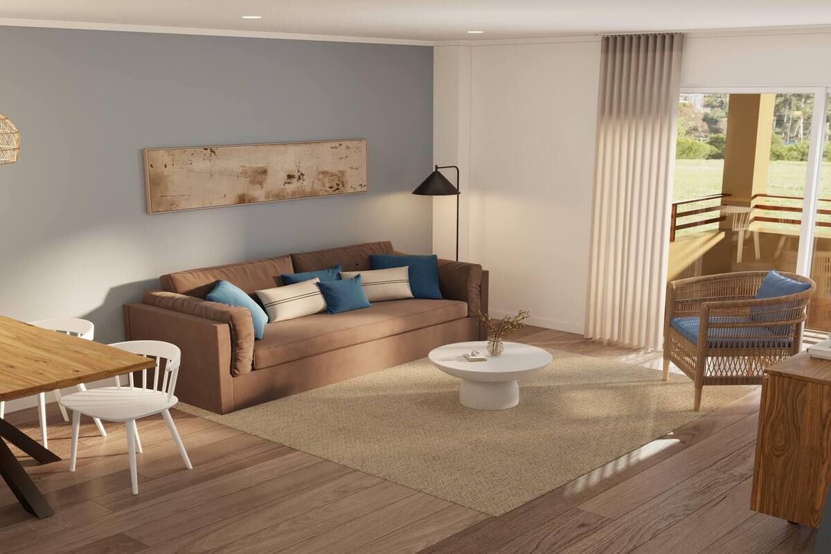 A modern living room with a brown sofa, white chairs, a wooden table, and a large window with a view of a garden.