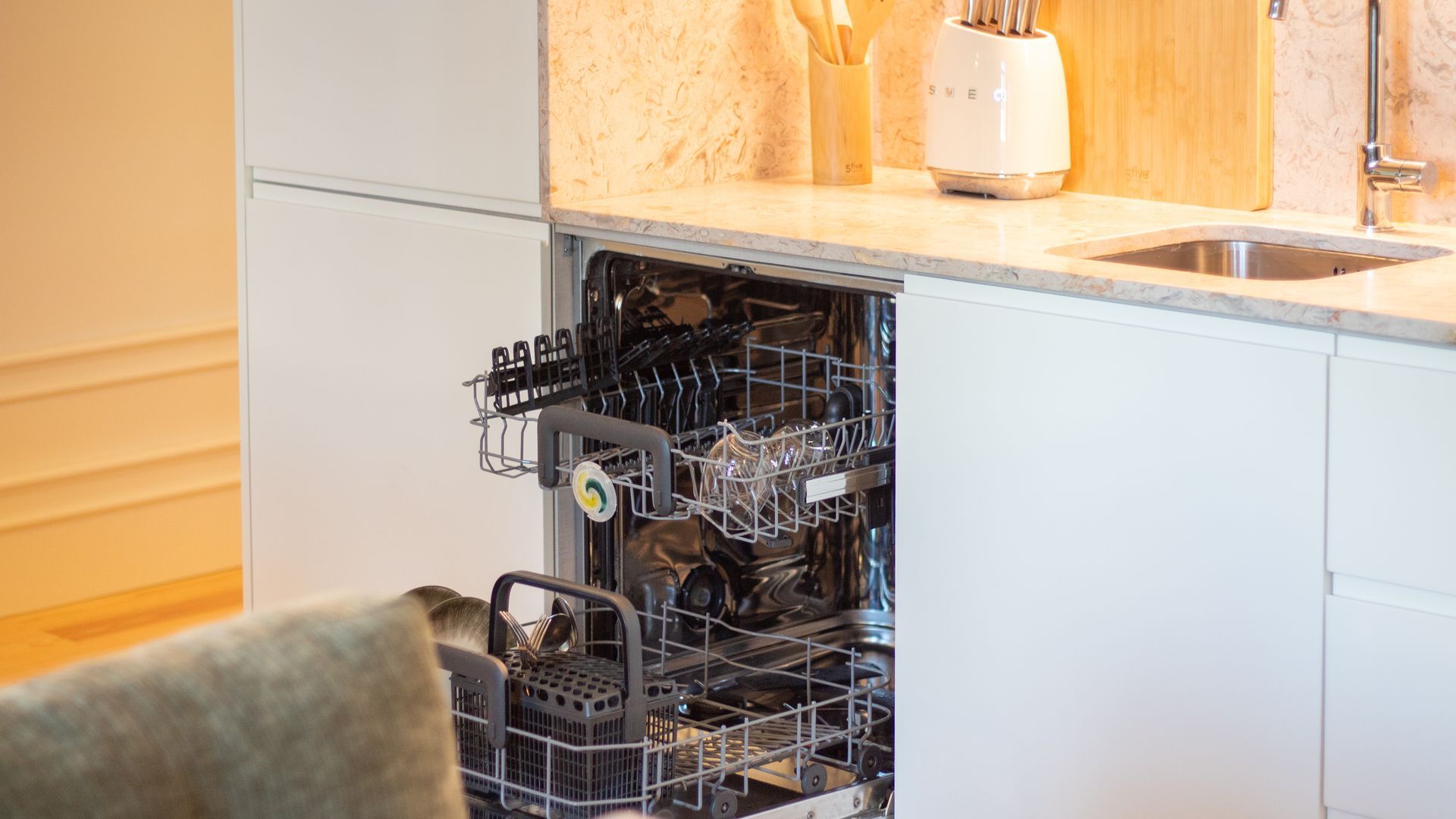 A kitchen with a dishwasher, a sink, and a toaster.