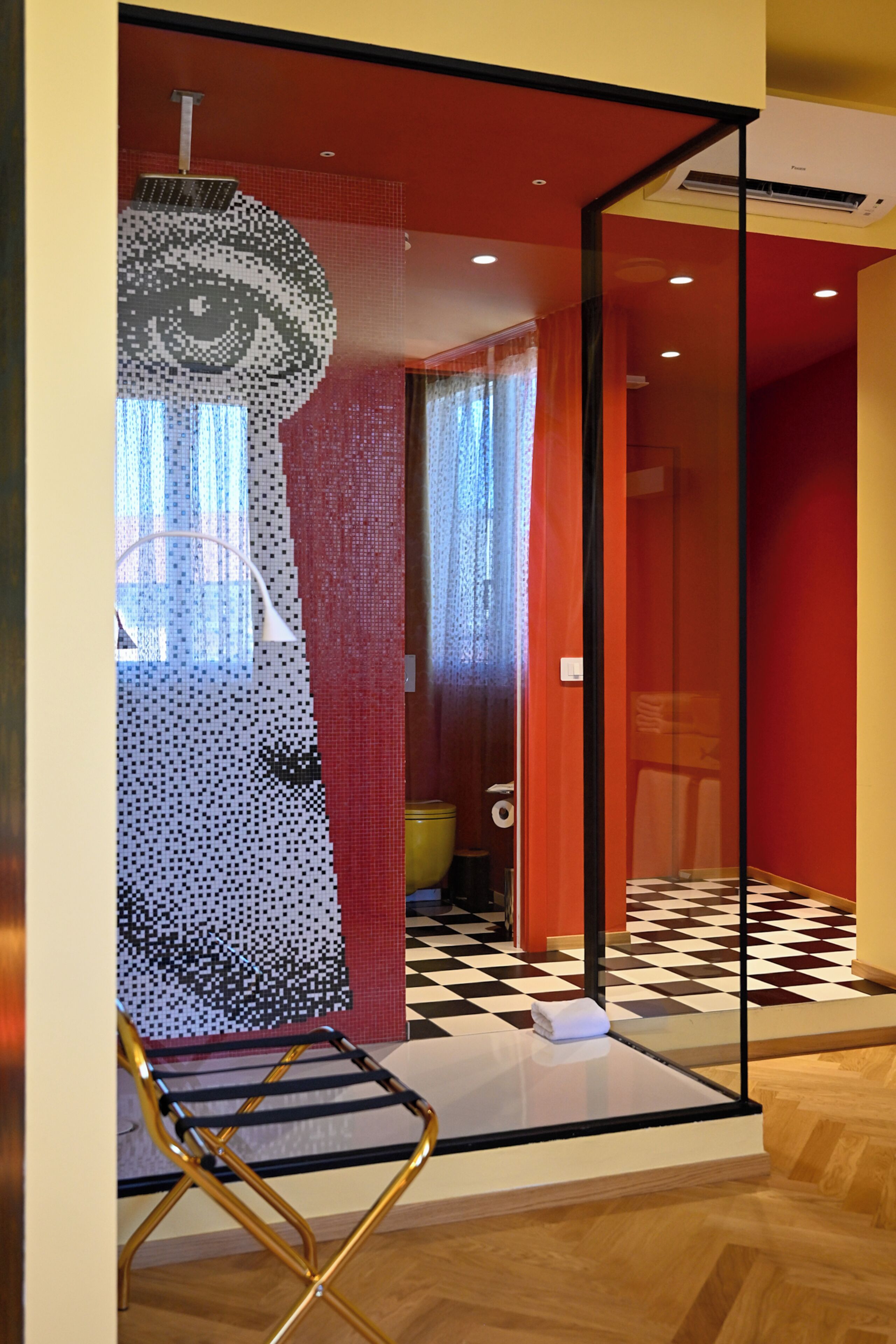 A modern interior with a checkered floor, a glass partition, and a unique wall art piece.