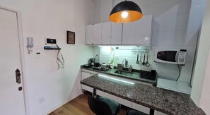 Fridge, microwave, stovetop, coffee/tea maker