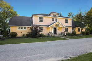 A two-story house with a front porch, a driveway, and a well-maintained lawn. - Alden East Torch Estate (Alden)