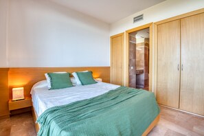 Ein Schlafzimmer mit einem Bett, Nachttischen, einem Kleiderschrank und einem Schrank.