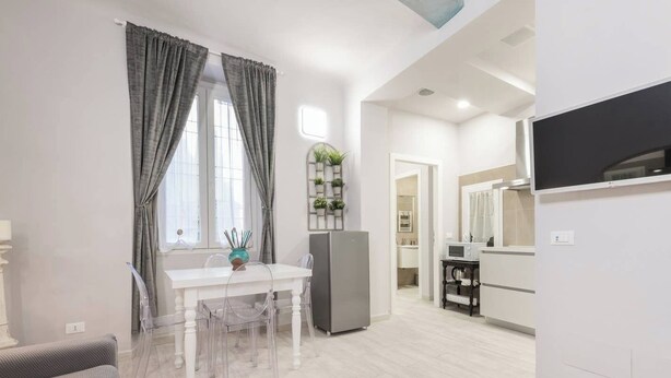 A modern apartment with a dining area, kitchen, and living space. - Double apartment with 2 independent entrances in the historic center of Florence (Firenze)