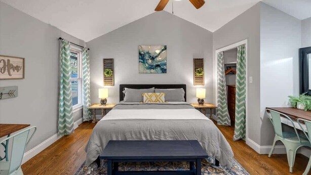 A bedroom with a bed, bedside tables, a ceiling fan, a desk, and a chair. - Farm Suite, King bed, firepit, BBQ grill, animals! (Asheville)