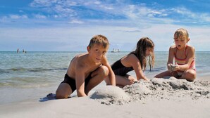 Three children playing on a sandy beach with the ocean in the background. - 2 Person Holiday Park Home in Nexo (Nexø)