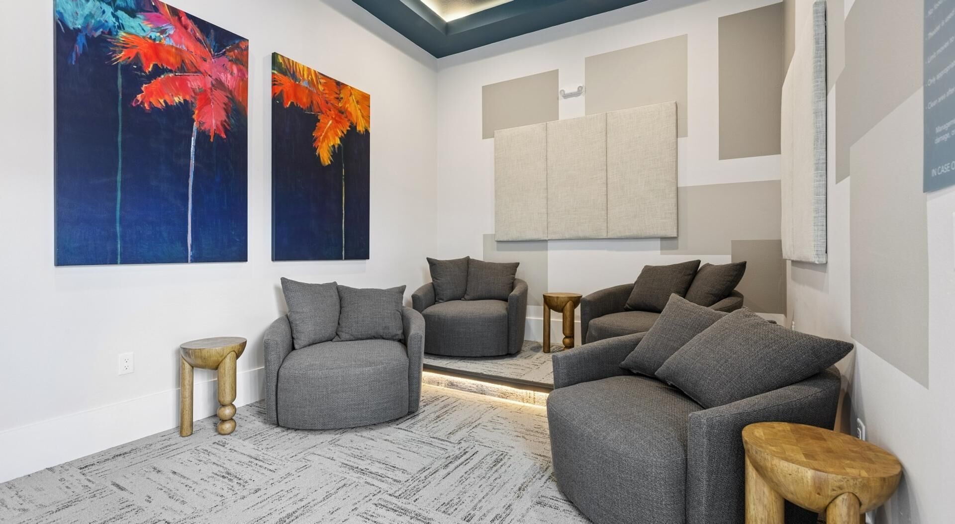 A modern living room with a sofa set, a round wooden table, and two side tables.