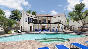 A two-story building with a swimming pool, blue lounge chairs, and a covered patio area. - Landing Apartments Near AT&T Stadium & Six Flags (Arlington)