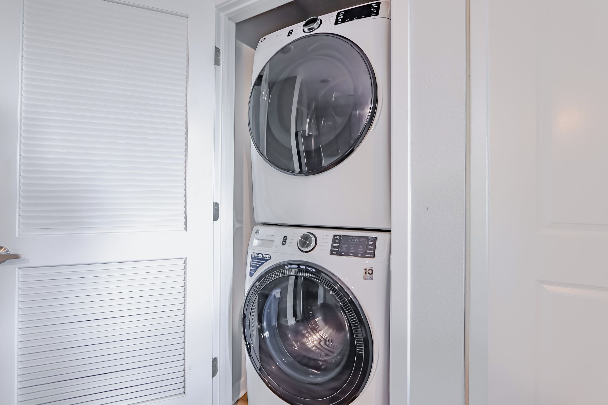 A laundry room with two front-loading washing machines.