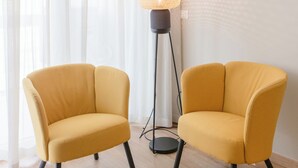 A room with two yellow armchairs, a floor lamp, and a painting on the wall. - [Bari Oberdan Home & Charm 1] Central Apartment (Bari)