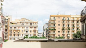 A multi-story residential building with balconies, a central courtyard, and a Ferris wheel in the background. - [Bari Oberdan Home & Charm 1] Central Apartment (Bari)