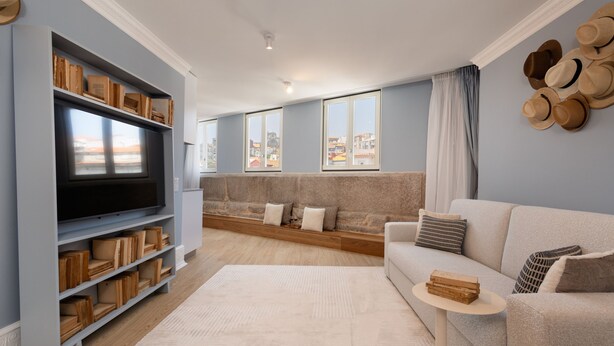 A modern living room with a large flat-screen TV, built-in shelves, a sofa, and a coffee table. - RA - Flores 3 in Oporto (Porto)