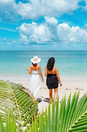 Two people walking on a beach with clear blue water and a bright sky. - Amazing ocean front 6-bedroom villa in Grand-Case Saint-Martin (Grand-Case)
