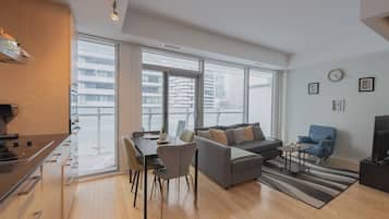 Deluxe Double Room, Balcony, City View | Living area | 60-inch LED TV with cable channels