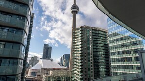 A modern urban skyline with high-rise buildings, a prominent tower, and a dome structure.