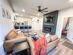A modern living room with a sofa set, a coffee table, and a fireplace. - 22 N Chestnut (Colorado Springs)