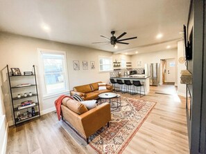 A spacious living area with a sofa set, a coffee table, and a patterned rug. - 22 N Chestnut (Colorado Springs)