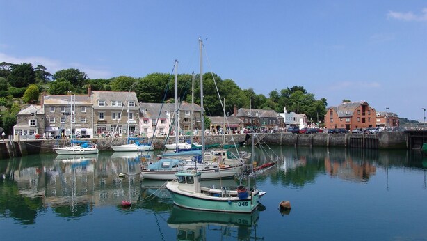 A harbor with boats docked, buildings along the waterfront, and a clear sky. - Mount Pleasant (Padstow)