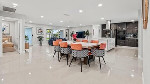 A modern kitchen with dark cabinets, a stainless steel refrigerator, and a microwave. - Villa Bonita Tropical Paradise Pool (Hollywood)