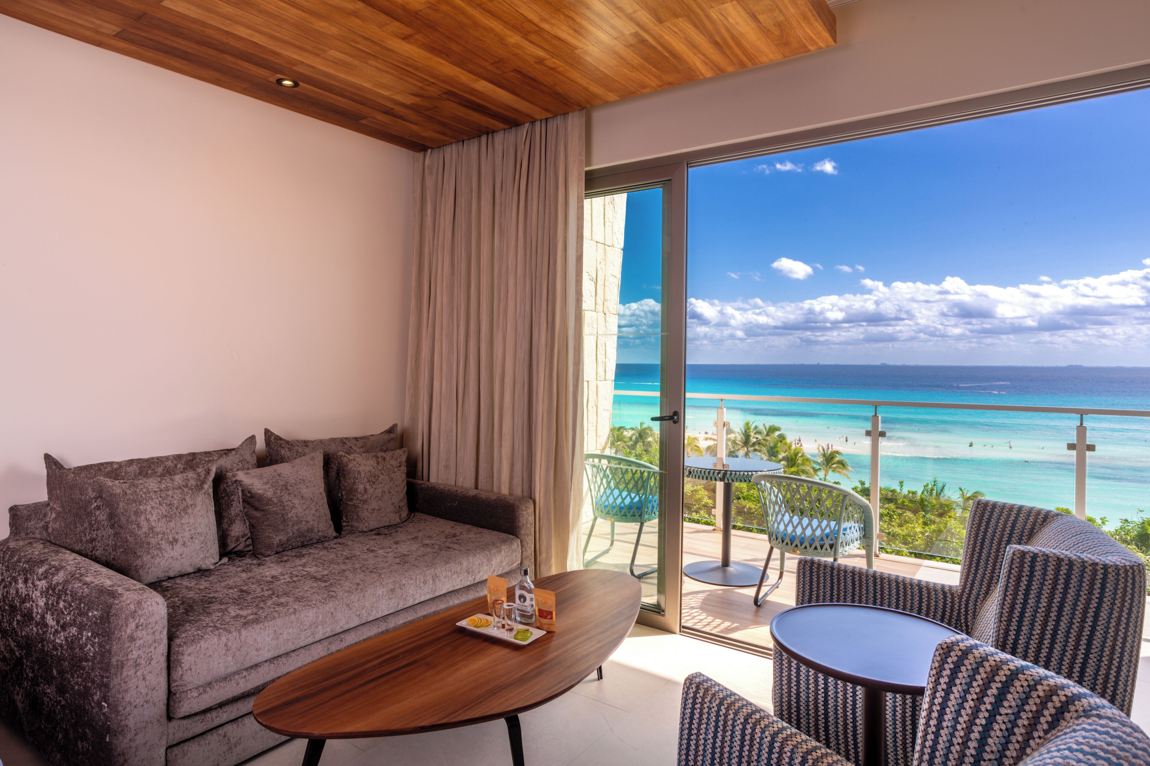 Platinum King Junior Suite Ocean Front | Living area | 50-inch Smart TV with cable channels