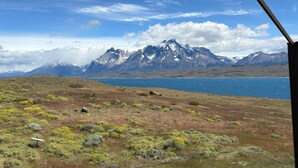 A mountainous landscape with a lake and a clear sky.