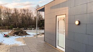 A modern building with a glass door and a metal exterior. - Awesome home in Ringkøbing with WiFi (Ringkøbing)