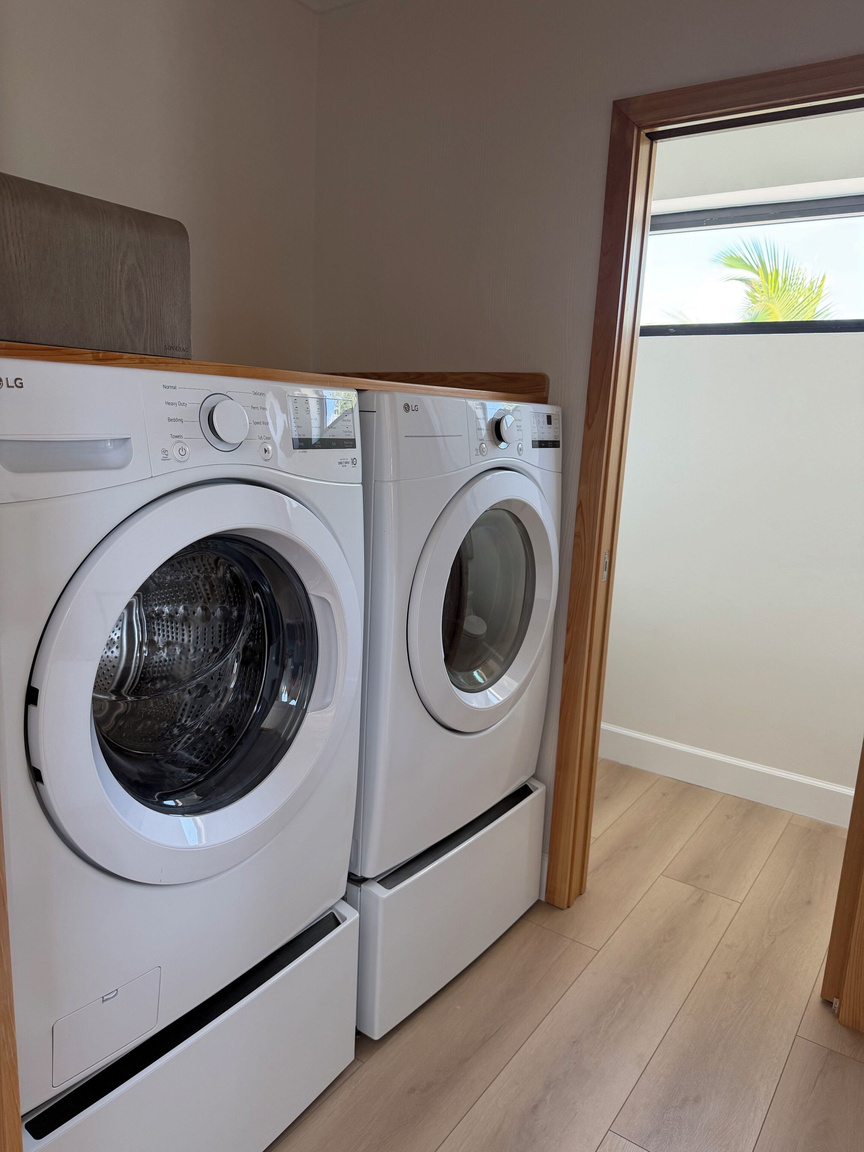 A laundry area with two LG front-loading washing machines.