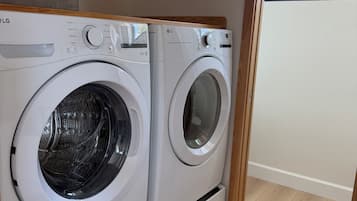 A laundry area with two LG front-loading washing machines.