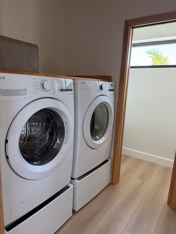 A laundry area with two LG front-loading washing machines.