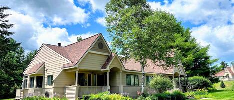 A single-story house with a gabled roof, a front porch, and a well-maintained lawn.