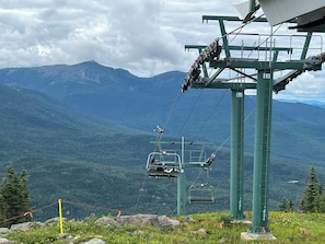 A cable car system with a mountainous landscape in the background.