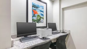 A workspace with two monitors, a keyboard, a mouse, and a printer on a marble desk. - Best Place to Stay for the Jeep Beach Week at Daytona Beach, FL - 1 BD/1 BA (Daytona Beach)