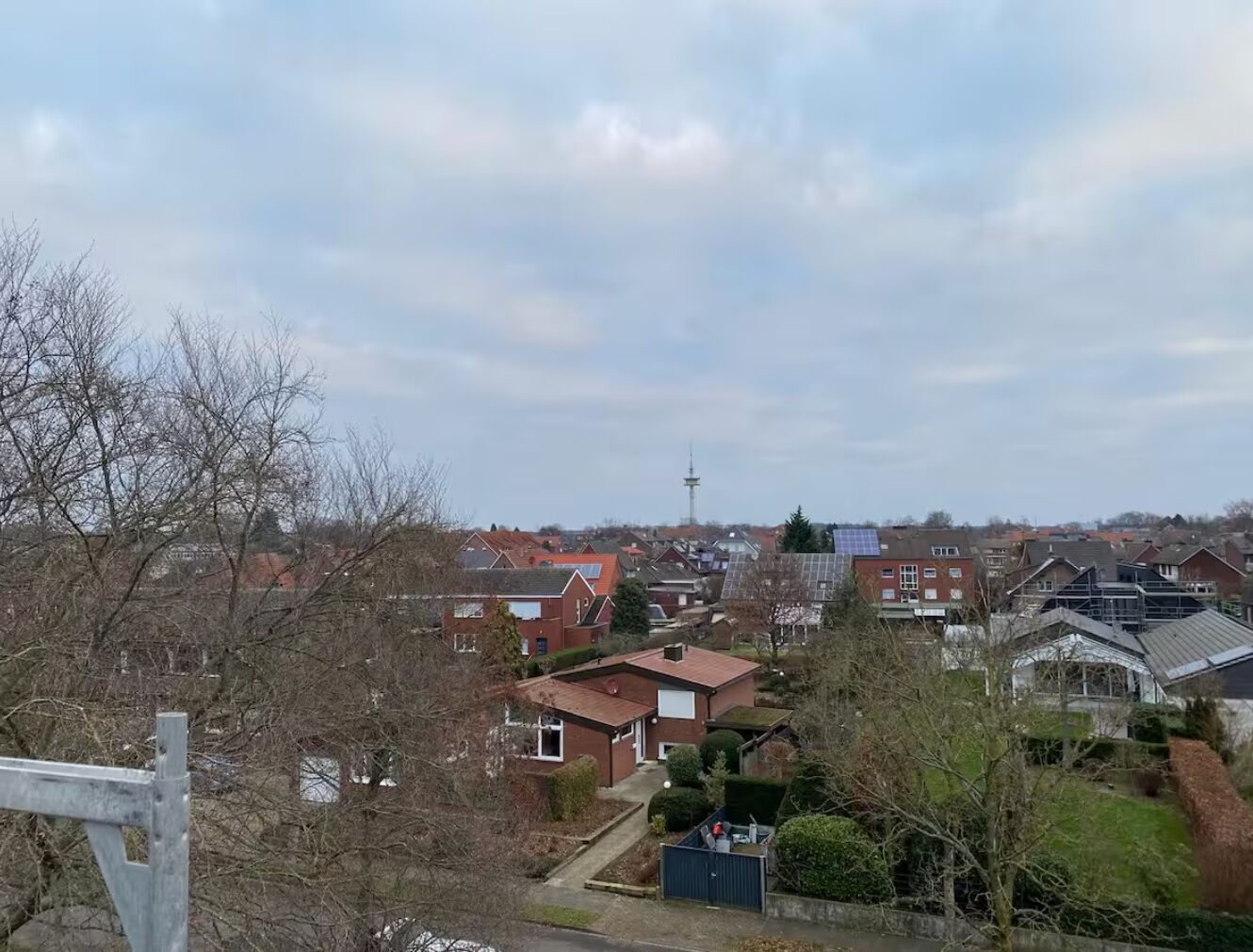 A residential area with houses, a tower, and a solar panel.