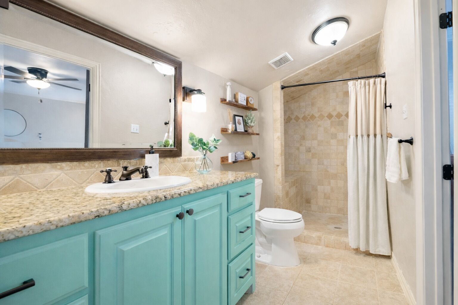 A bathroom with a sink, mirror, and toilet.