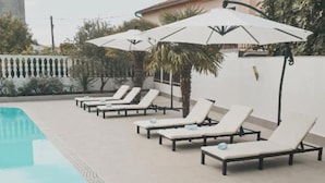 A poolside area with lounge chairs and umbrellas. - Hotel Orion Vodice - Double bed with balcony 1 (Vodice)