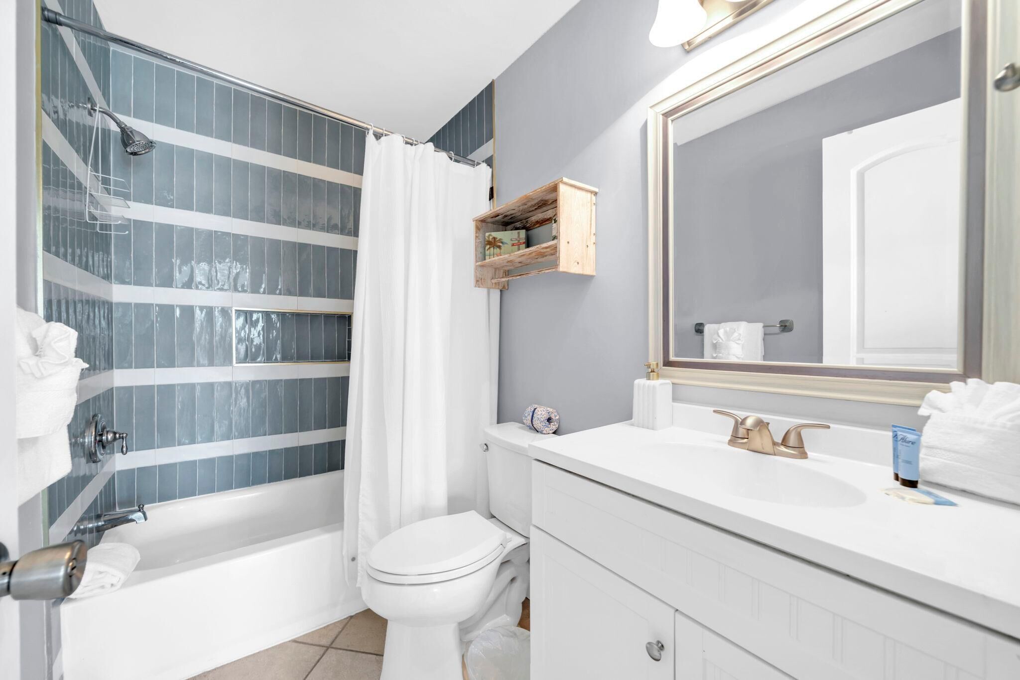 A bathroom with a bathtub, toilet, and sink.